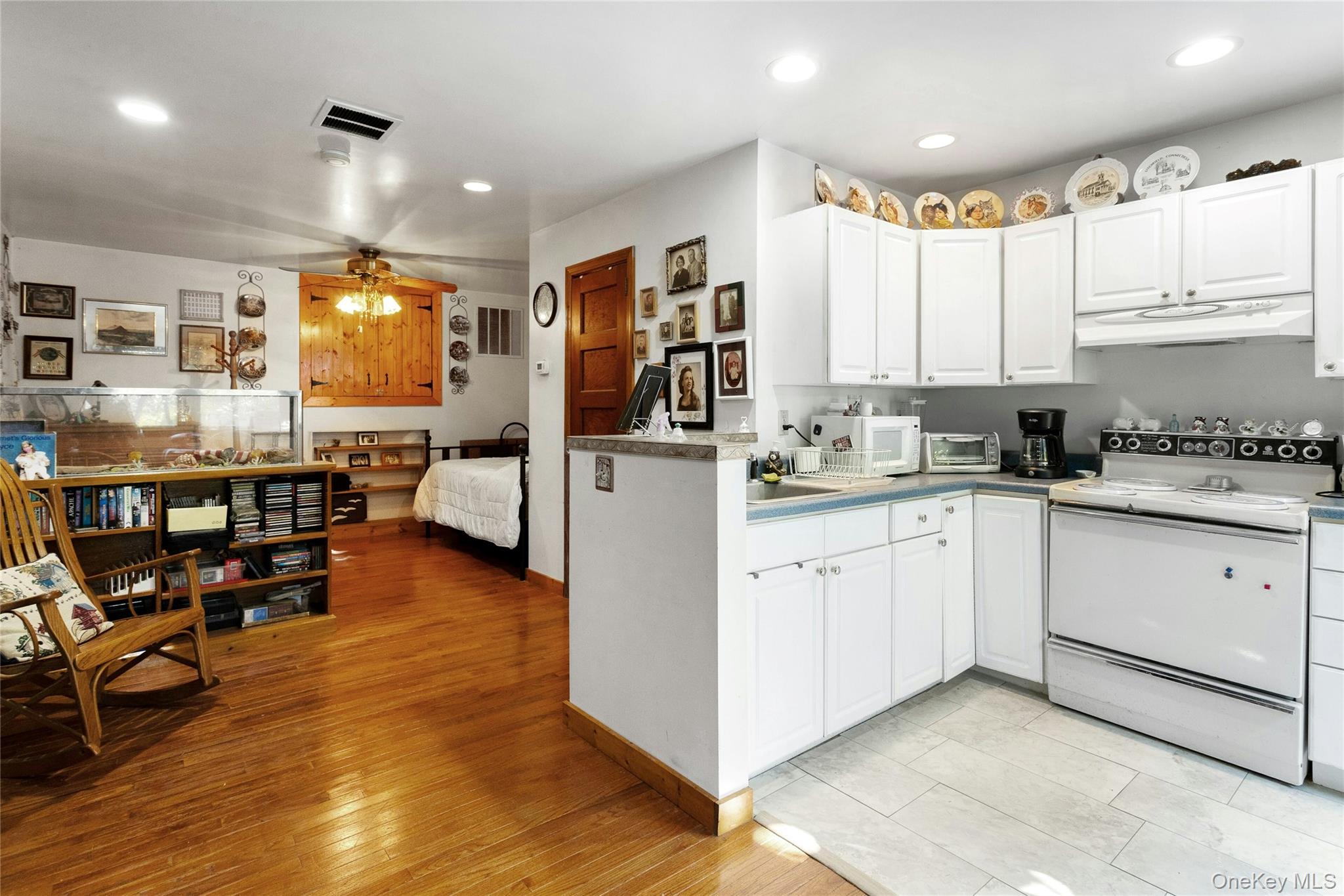 73 Lake Ellis Road Wingdale, NY 12594 - Photo 8 of 41 Kitchen featuring white appliances, recessed lighting, white cabinetry, a ceiling fan, and under cabinet range hood