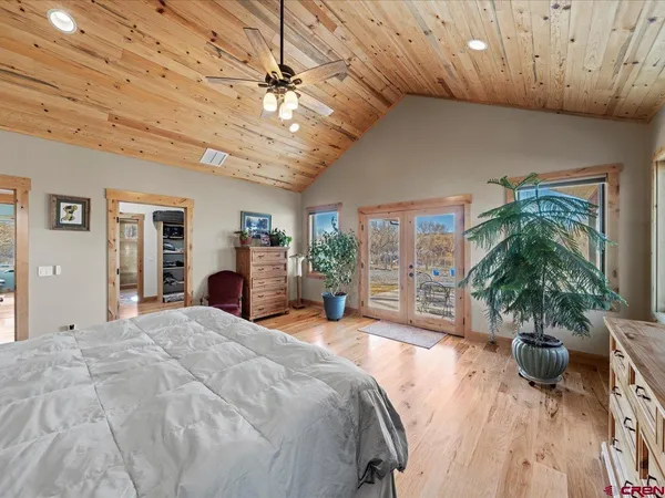 a bedroom with a large bed and a window
