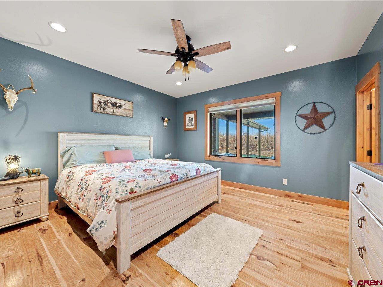 7528 South River Road Olathe, CO 81425 - Photo 25 of 44 a bedroom with a large bed and a window