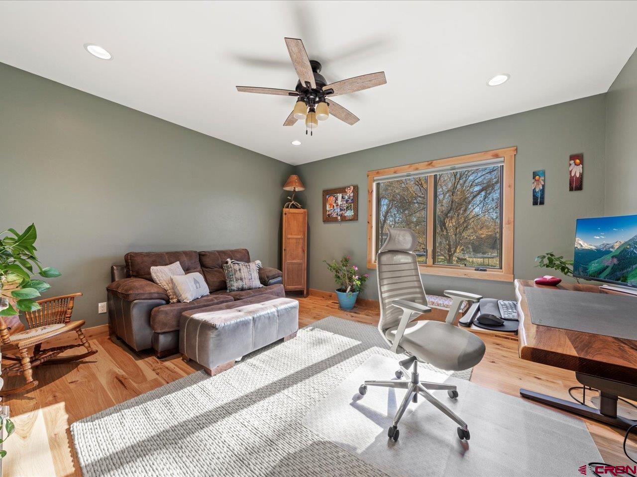 7528 South River Road Olathe, CO 81425 - Photo 29 of 44 a living room with furniture and a large window