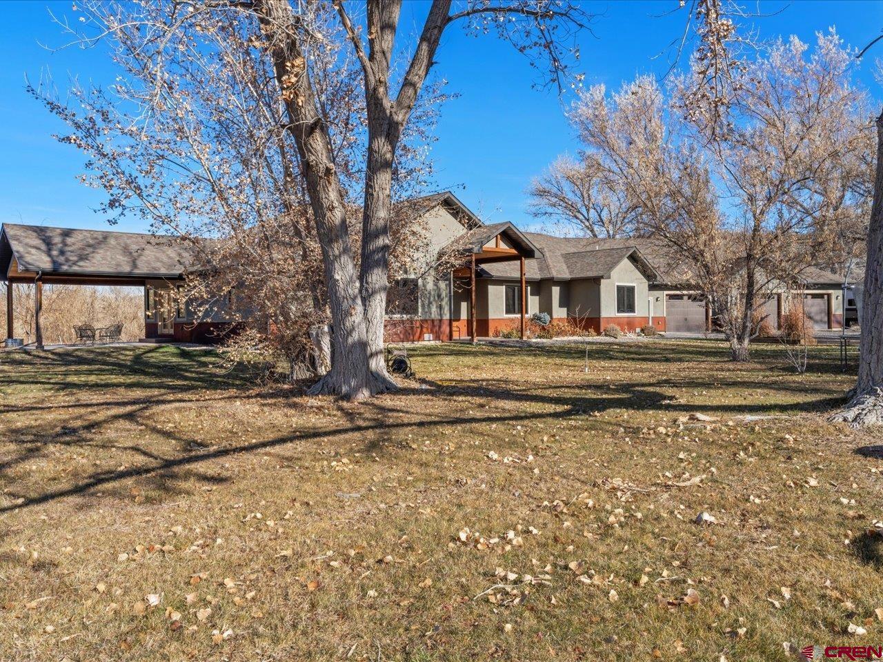 7528 South River Road Olathe, CO 81425 - Photo 43 of 44 a front view of a house with a yard