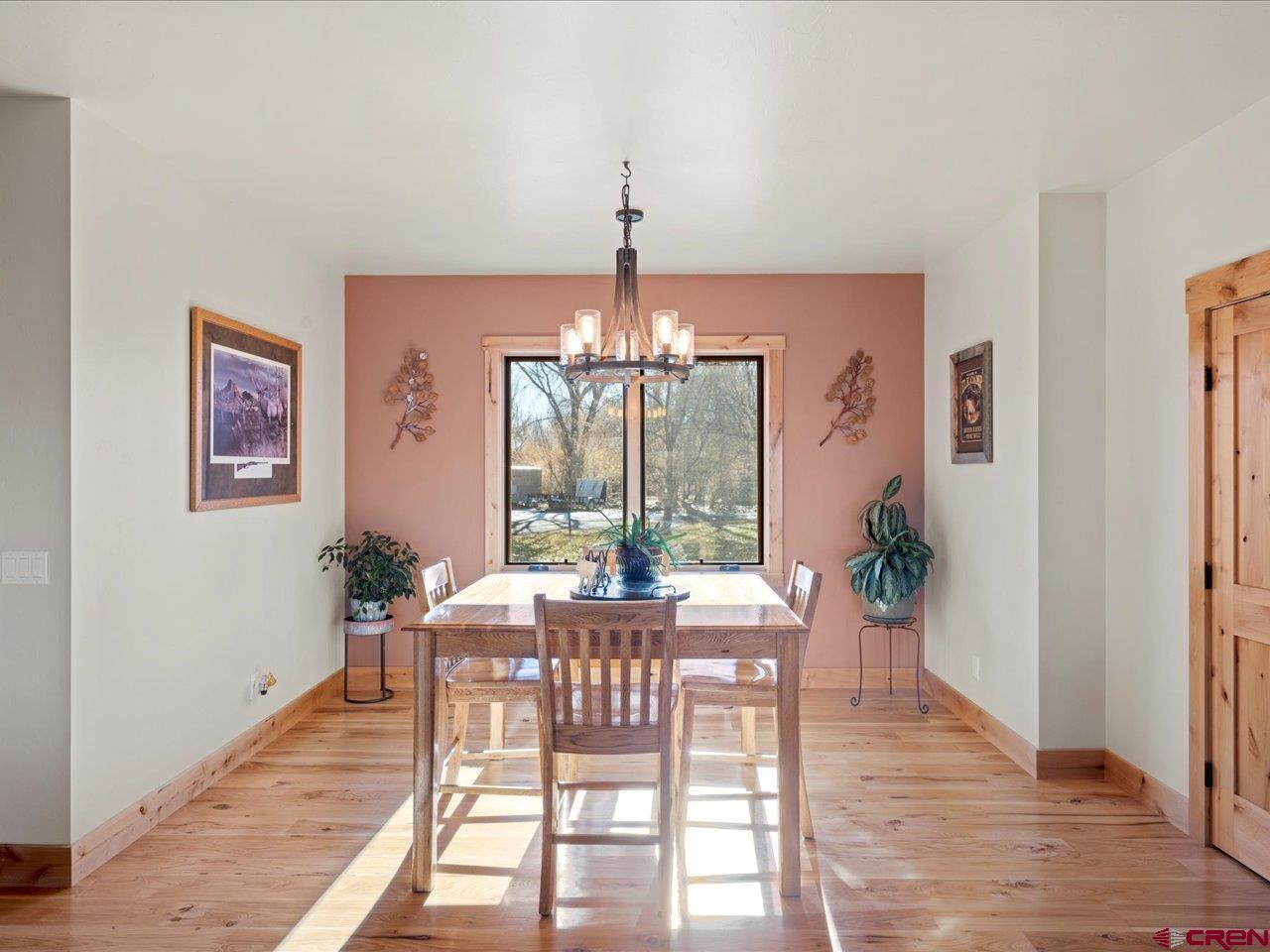 7528 South River Road Olathe, CO 81425 - Photo 6 of 44 a view of a dining room with furniture window and wooden floor