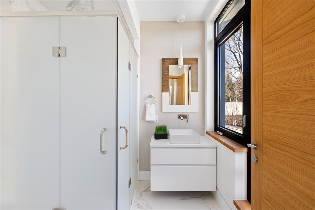 31 Catlin Road Brookline, MA 02445 - Photo 14 of 20 a bathroom with a sink and mirror