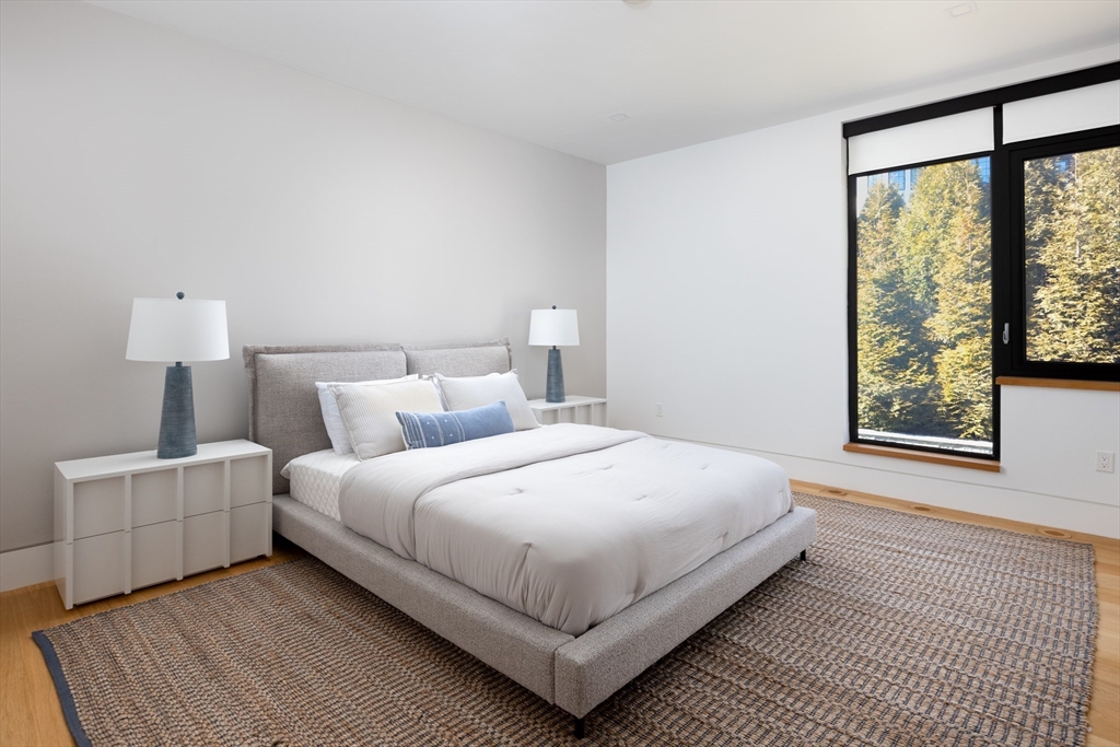 31 Catlin Road Brookline, MA 02445 - Photo 16 of 20 a large bed sitting in a bedroom next to a window