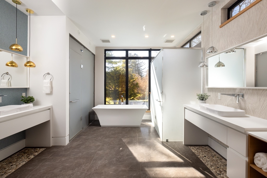 31 Catlin Road Brookline, MA 02445 - Photo 9 of 20 a bathroom with a tub sink and mirror