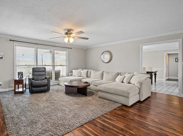a living room with furniture and wooden floor