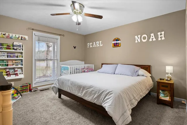 a spacious bedroom with a bed and a window