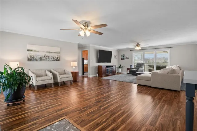 a living room with furniture or wooden floor and a large window