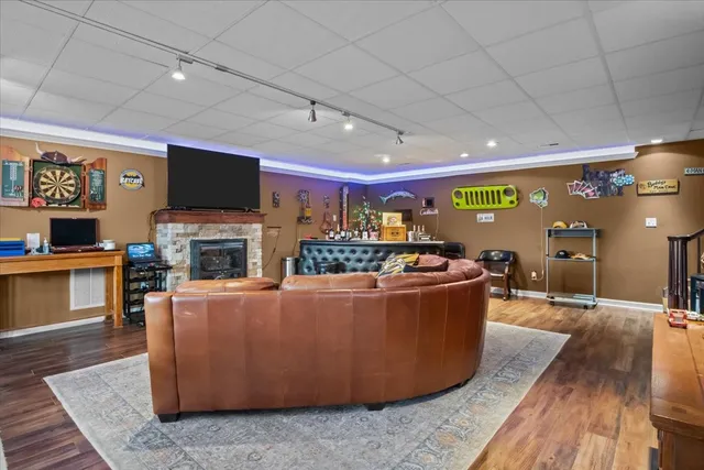 a living room with furniture a flat screen tv and a fireplace