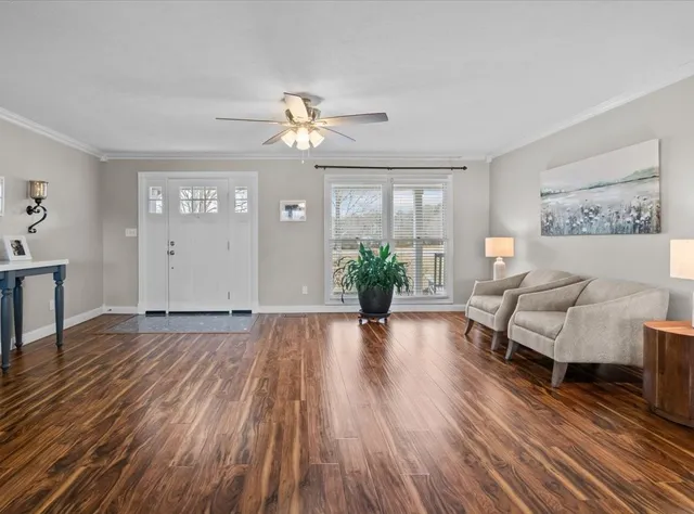 a living room with furniture and wooden floor