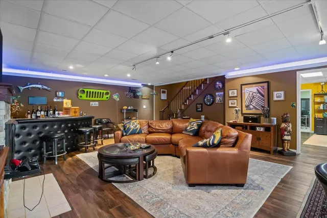 a living room with fireplace furniture and a flat screen tv