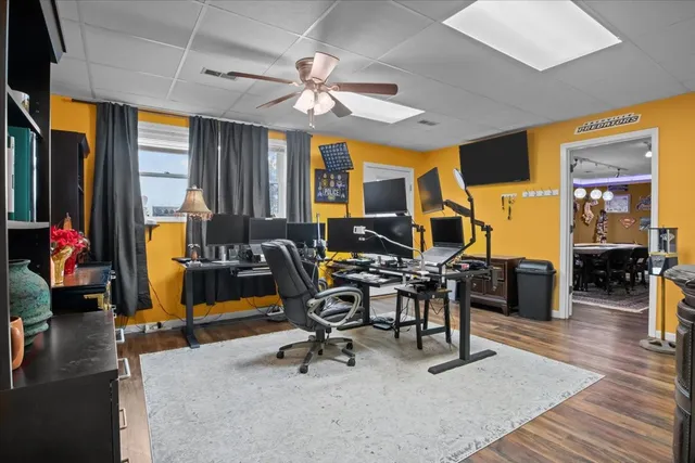 a view of a livingroom with workspace and a window