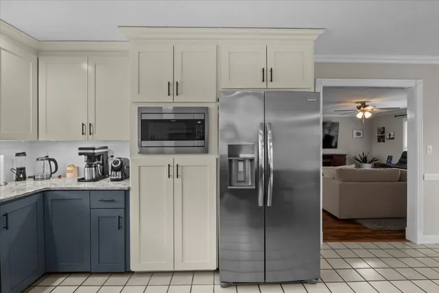 a kitchen with stainless steel appliances granite countertop a refrigerator a stove and a sink