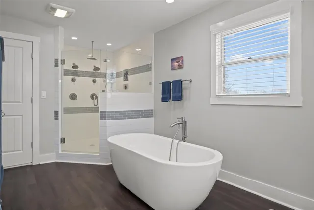 a bathroom with a bathtub and shower