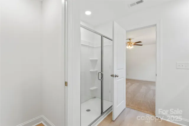 a bathroom with a glass shower door