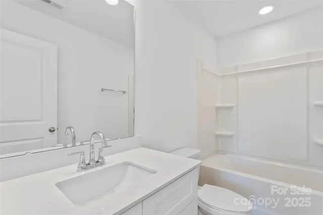 a bathroom with a sink toilet and a bathtub