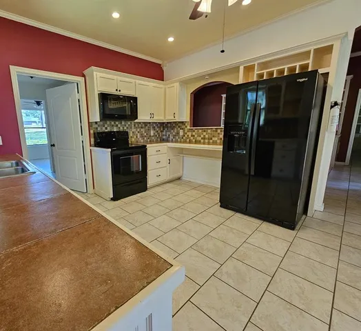 a kitchen with stainless steel appliances a refrigerator and a stove top oven