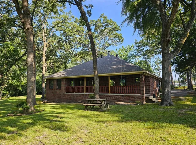 a view of house with yard and entertaining space