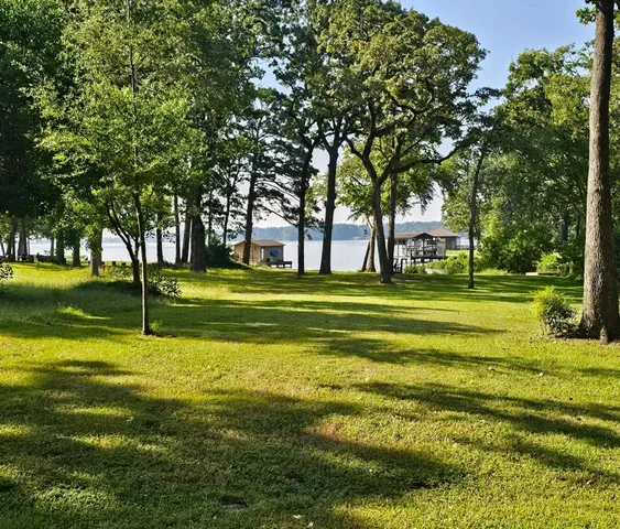 a swimming pool with outdoor seating and yard