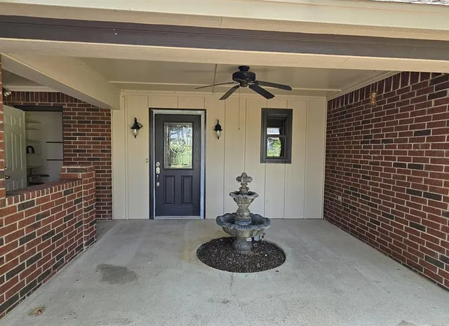 a living room with a couch and a potted plant