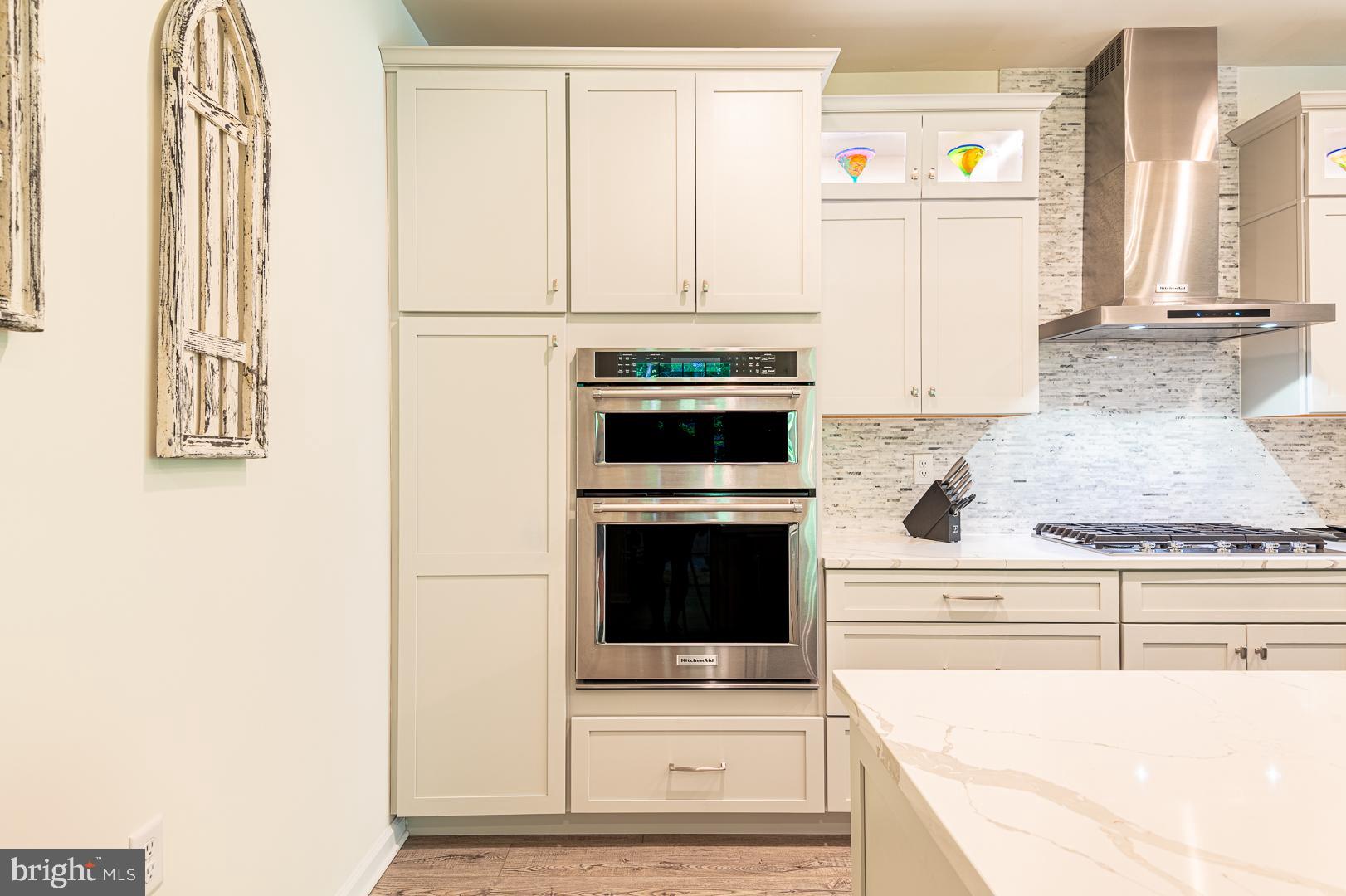 314 Tranquility Way Middletown, DE 19709 - Photo 14 of 56 a kitchen with granite countertop white cabinets and white appliances