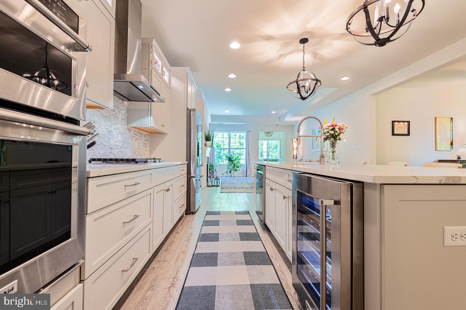 314 Tranquility Way Middletown, DE 19709 - Photo 17 of 56 a kitchen with stainless steel appliances a stove refrigerator and a sink