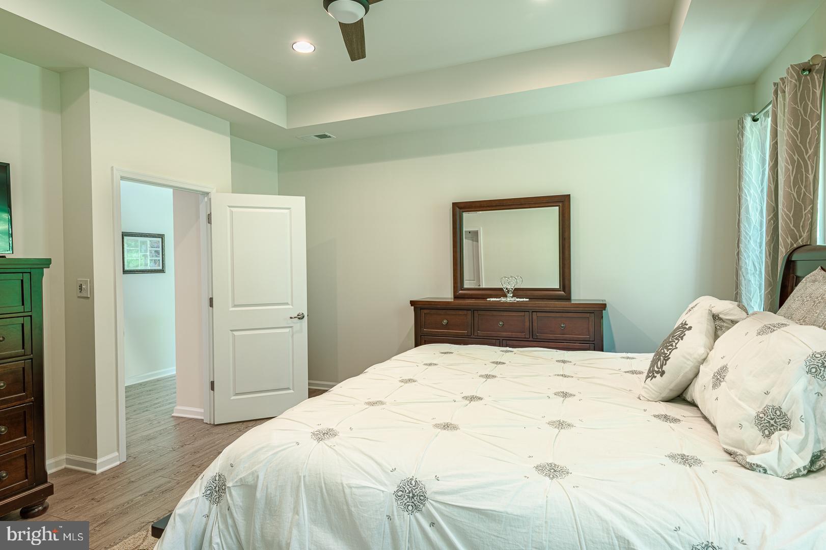 314 Tranquility Way Middletown, DE 19709 - Photo 24 of 56 a bedroom with a large bed and a mirror