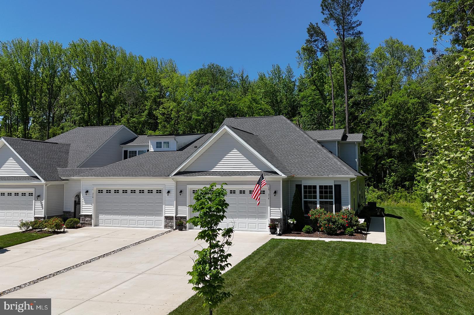 314 Tranquility Way Middletown, DE 19709 - Photo 3 of 56 a front view of a house with a yard garden and outdoor seating