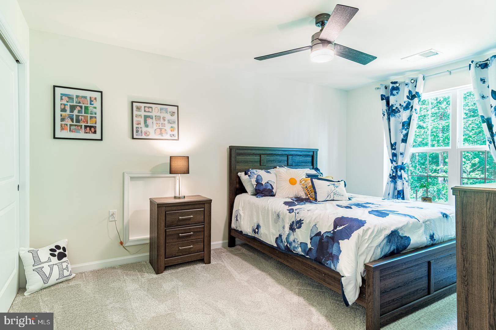 314 Tranquility Way Middletown, DE 19709 - Photo 37 of 56 a bedroom with a bed and a chandelier