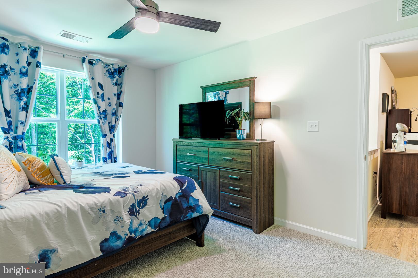 314 Tranquility Way Middletown, DE 19709 - Photo 38 of 56 a bedroom with a bed and a flat tv screen