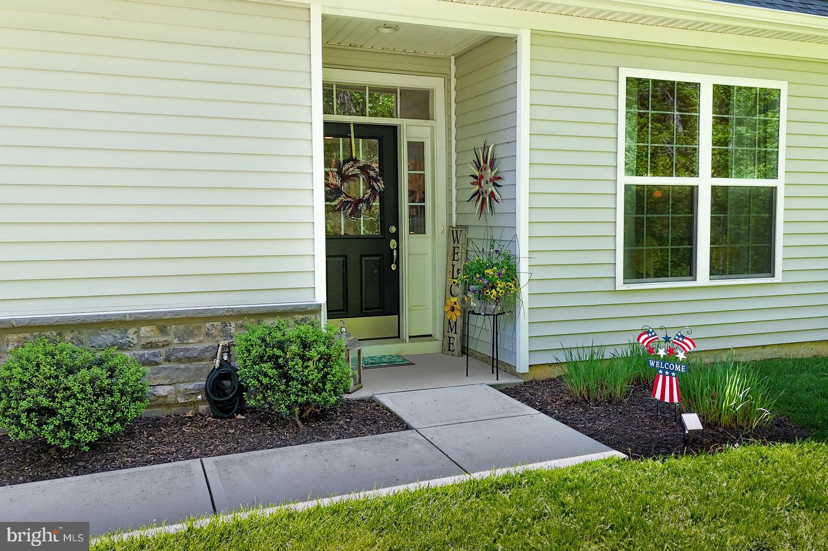 314 Tranquility Way Middletown, DE 19709 - Photo 4 of 56 a front view of a house with garden
