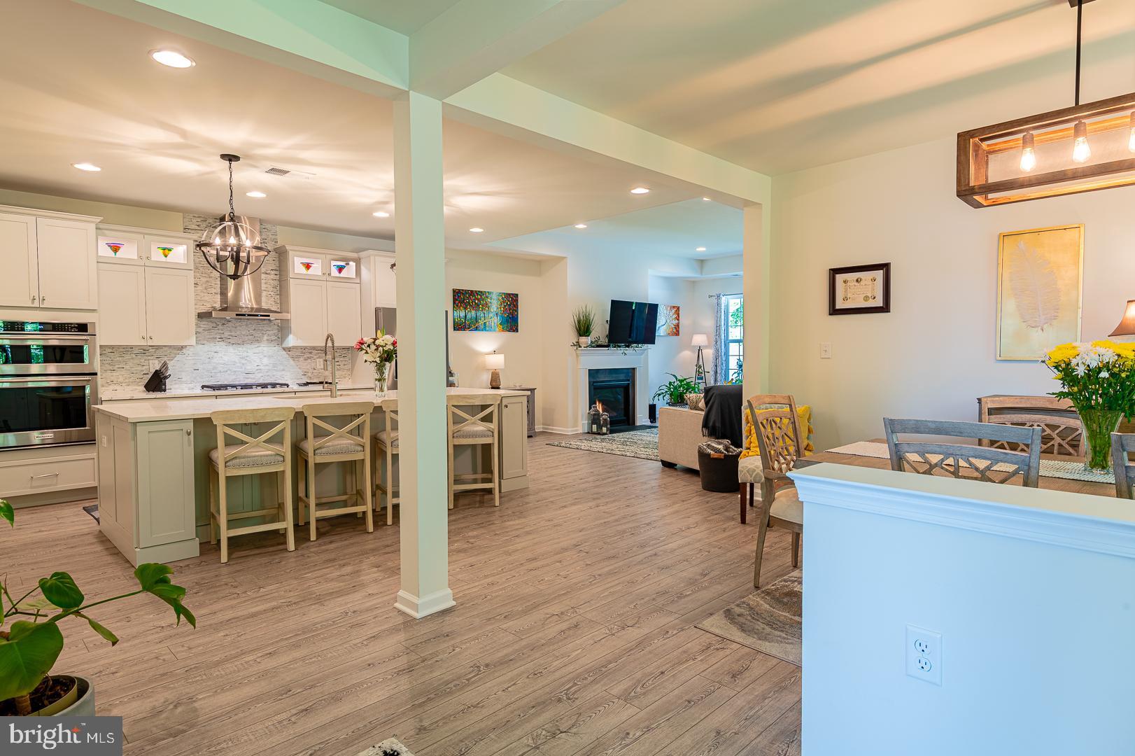 314 Tranquility Way Middletown, DE 19709 - Photo 54 of 56 a room with stainless steel appliances kitchen island granite countertop furniture and a wooden floor