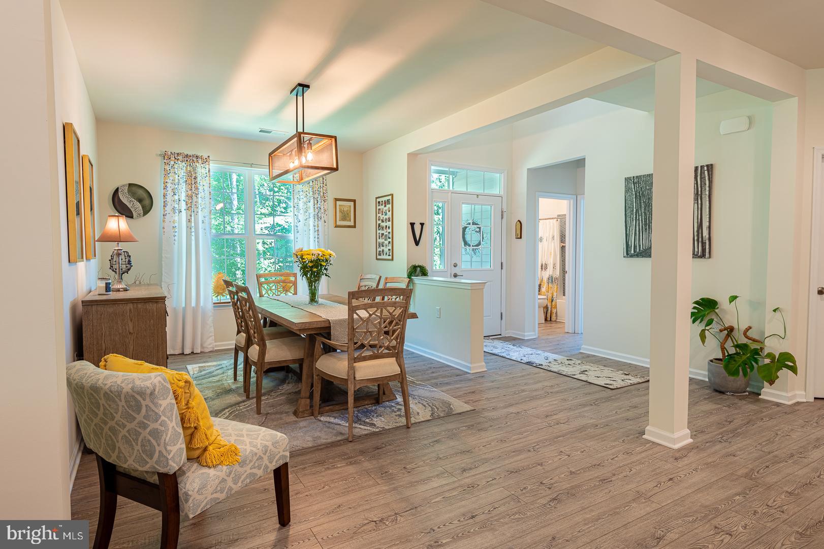 314 Tranquility Way Middletown, DE 19709 - Photo 6 of 56 a dining room with furniture potted plants and wooden floor