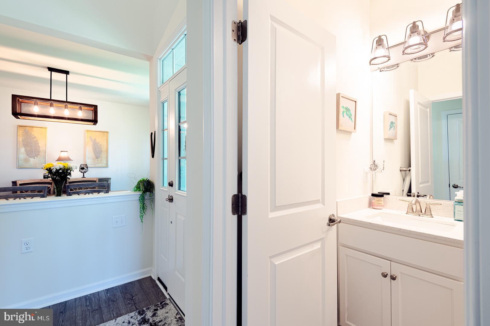 314 Tranquility Way Middletown, DE 19709 - Photo 7 of 56 a bathroom with a sink a mirror and a shower