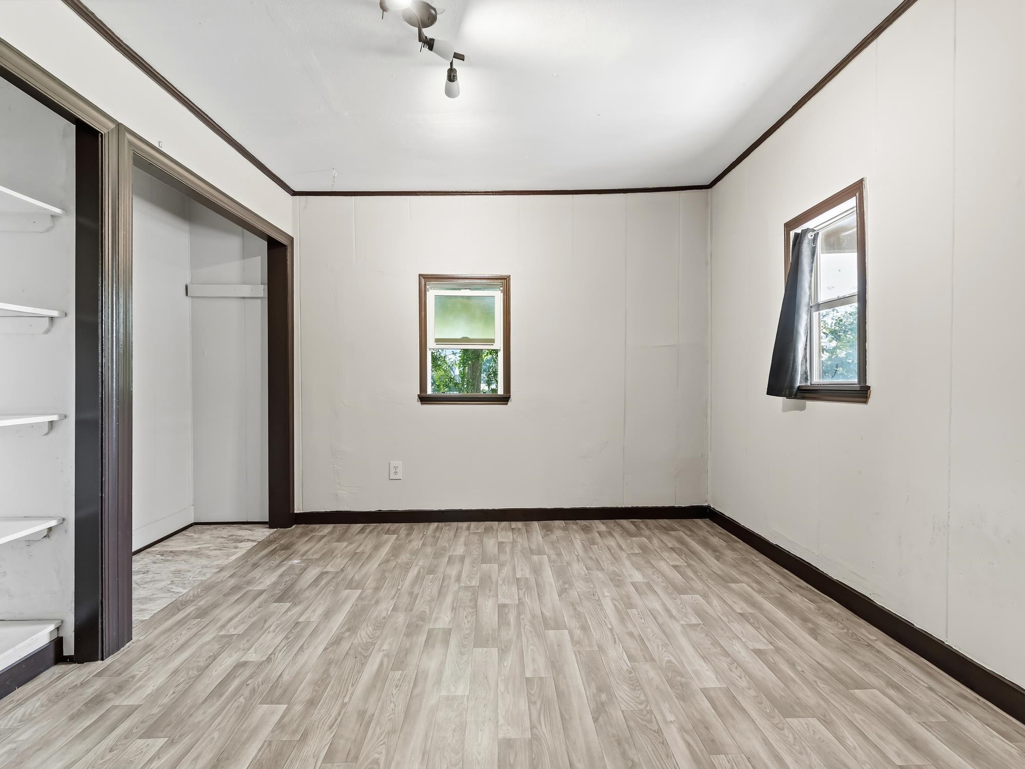 737 9th Street Port Arthur, TX 77640 - Photo 13 of 20 an empty room with wooden floor and windows