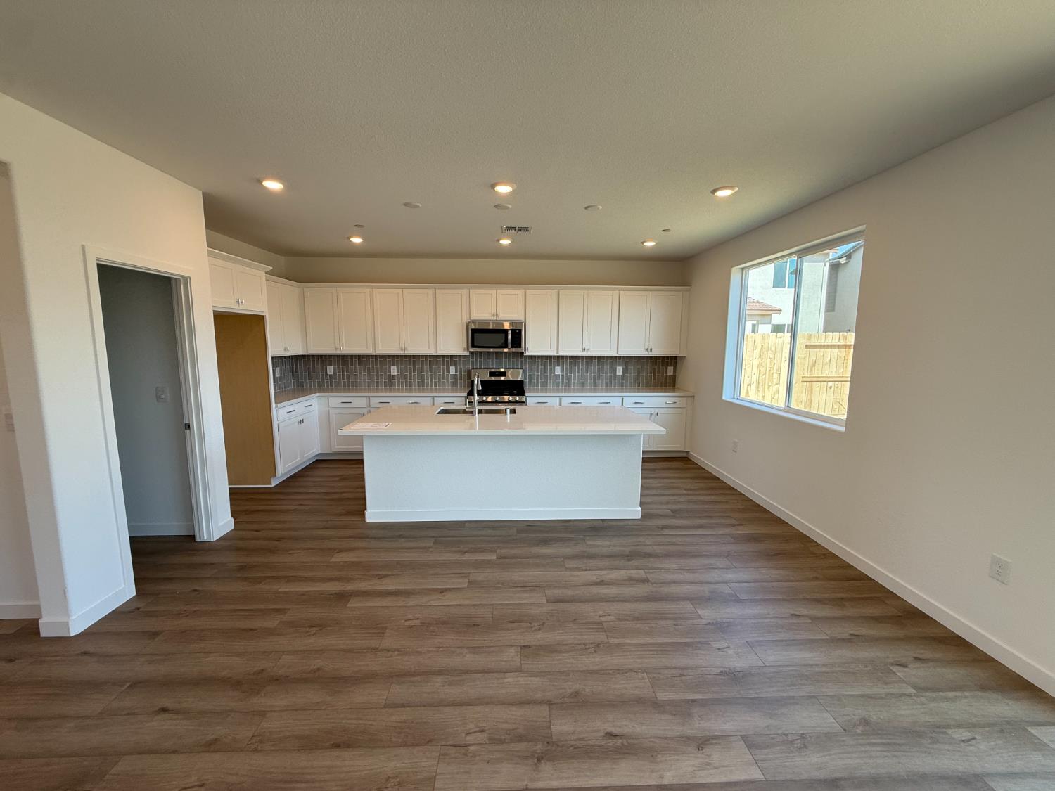 10355 Cadette Way Elk Grove, CA 95757 - Photo 3 of 15 a view of kitchen with granite countertop refrigerator oven a sink and dishwasher with wooden floor
