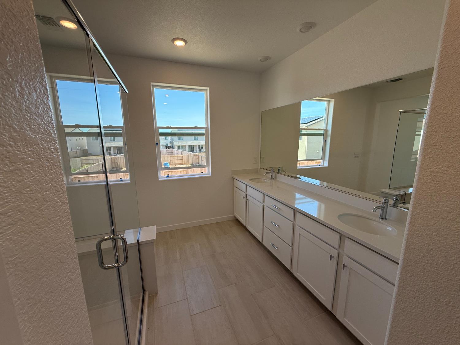 10355 Cadette Way Elk Grove, CA 95757 - Photo 6 of 15 a bathroom with double vanity and a mirror