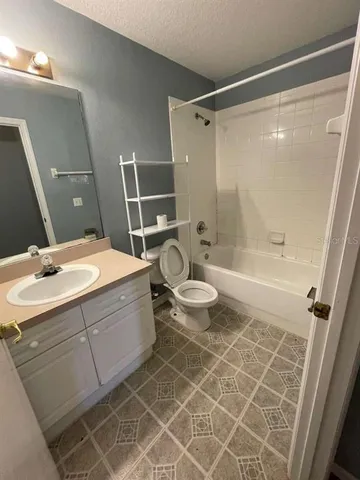 a bathroom with a double vanity sink toilet mirror and shower