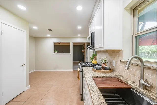 a kitchen with sink refrigerator and stove