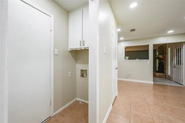 a view of a hallway with wooden shelves
