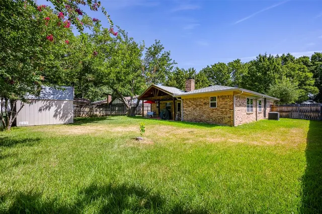 a view of a backyard with a tree