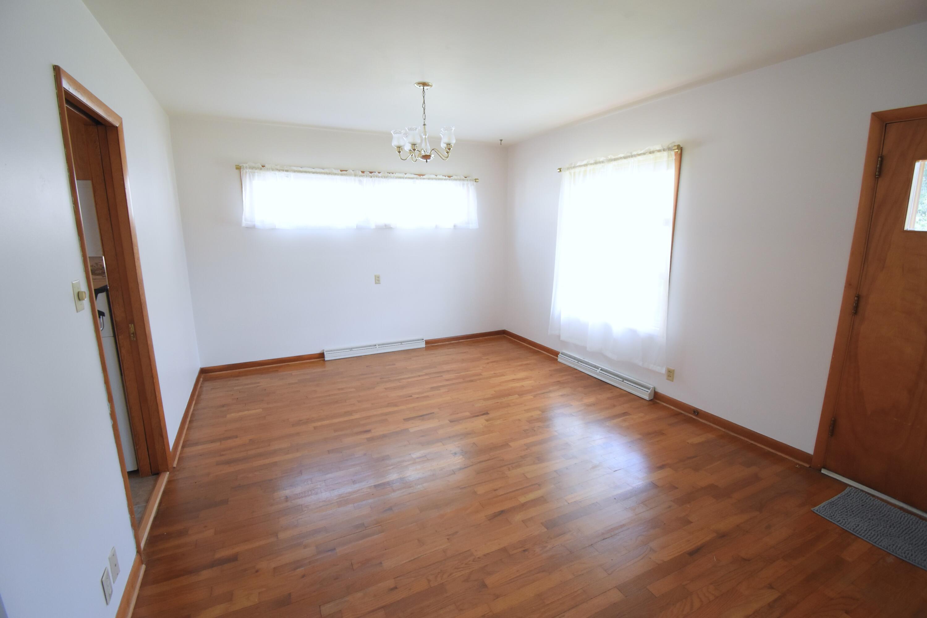 328 South Weston Street Rensselaer, IN 47978 - Photo 11 of 39 an empty room with wooden floor and windows