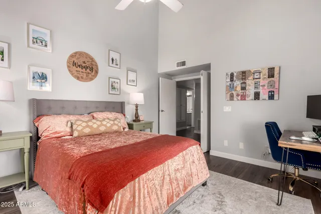 a bedroom with a bed a desk and chair