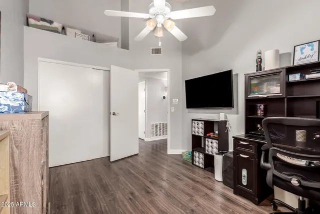 a bathroom with a granite countertop sink a toilet and a mirror