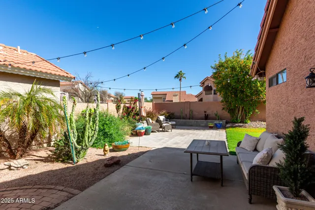a backyard of a house with outdoor seating