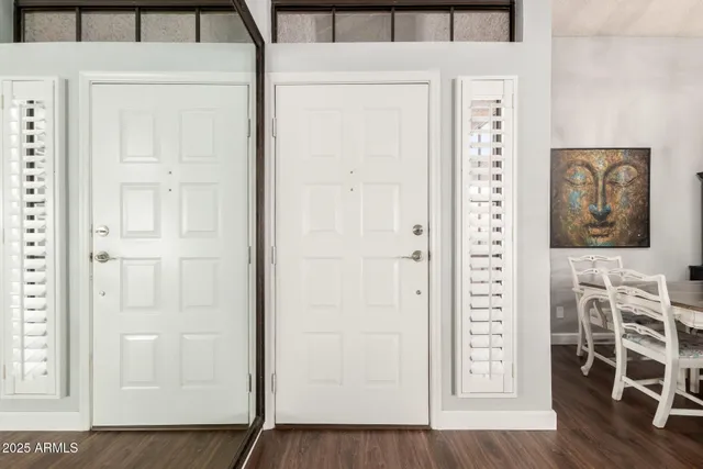 view of front door with wooden floor