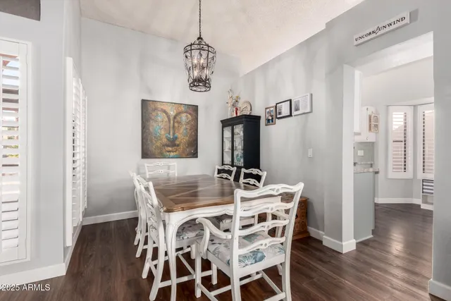 a view of a dining room with furniture wooden floor and chandelier