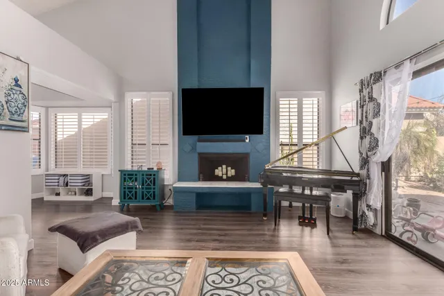 a living room with furniture a fireplace and a flat screen tv