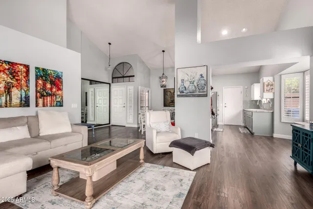 a living room with furniture and wooden floor