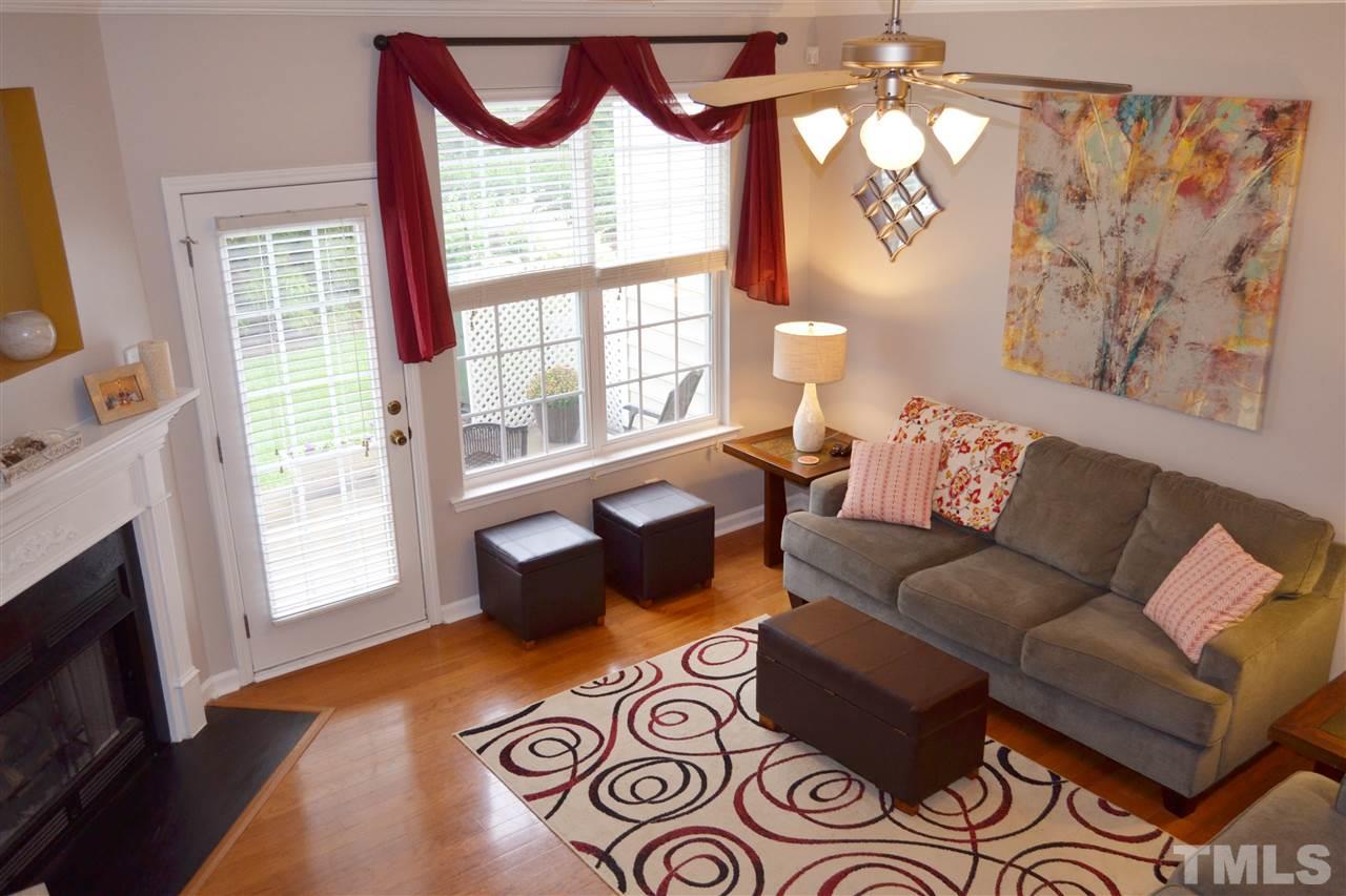 7840 Silverthread Lane Raleigh, NC 27617 - Photo 2 of 21 a living room with furniture and a fireplace